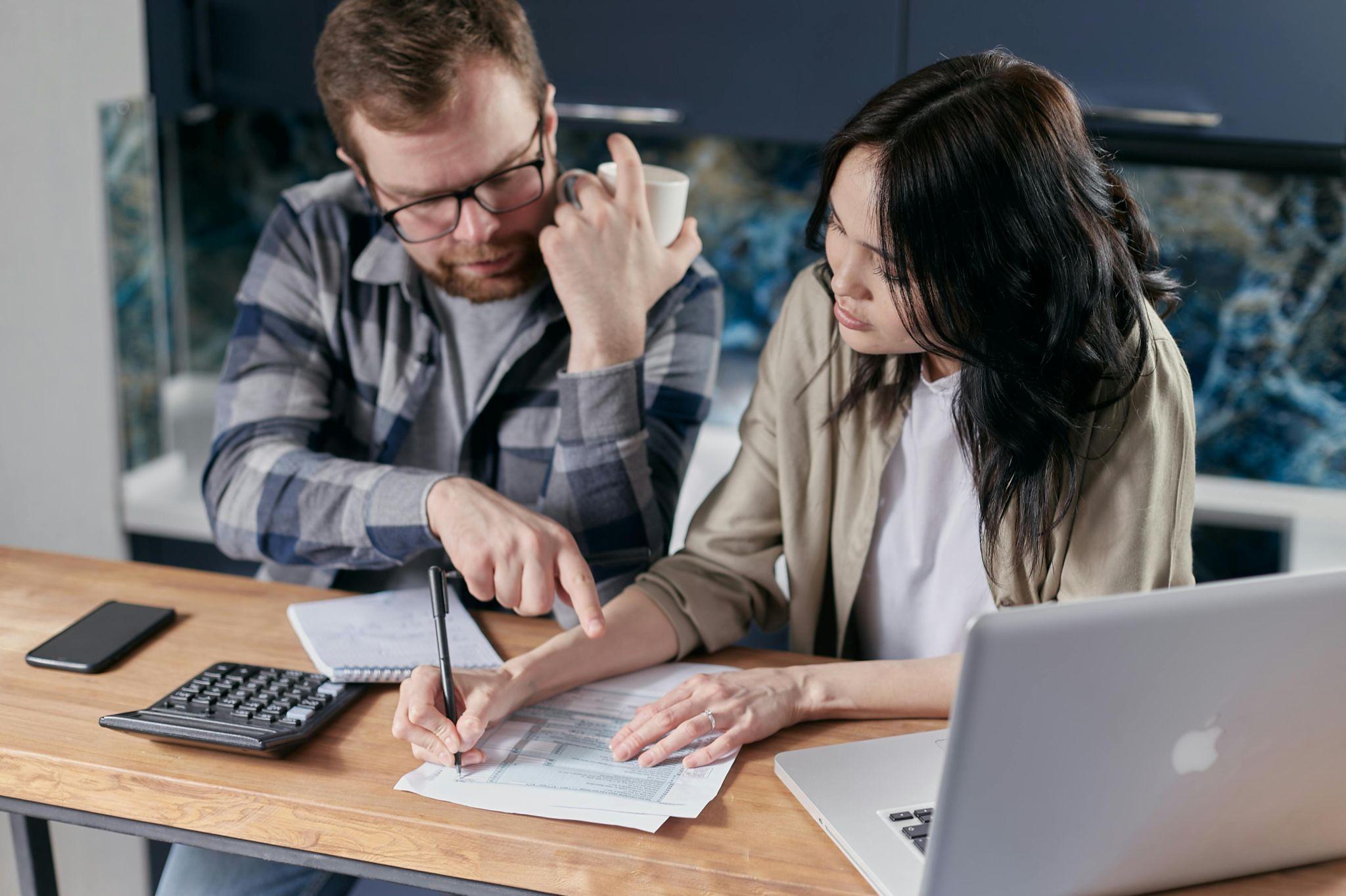 A couple reviewing financial documents together at home