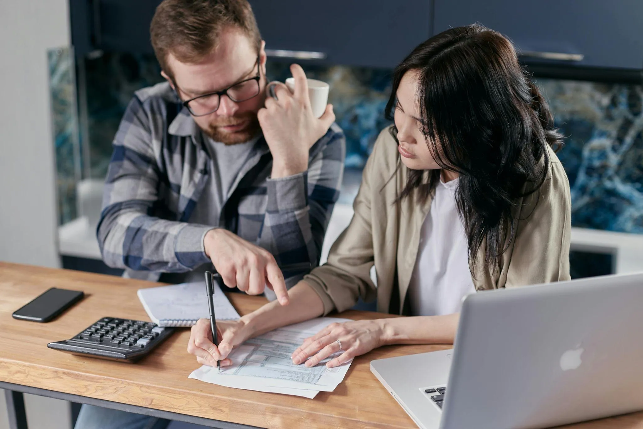 A couple reviewing financial documents together at home